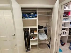 Built-in closet with white shelving, hanging rods, and organized storage compartments