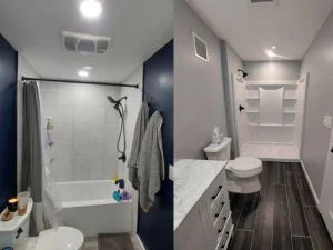 Renovated bathroom with navy accent wall, white subway tile shower, dark tile flooring, and updated fixtures